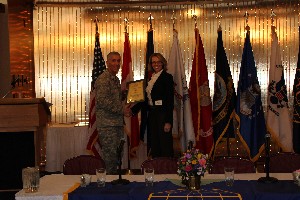 Col. Platt presents Kelly McCready of Responsive Geospatial Systems LLC with a corporate membership plaque at the March meeting.
